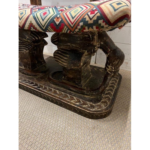 138 - A South African carved bench seat with a kilim style, upholstered and carved birds to back and base