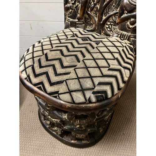 139 - A pair of carved seats with tribal theme carving to back and base