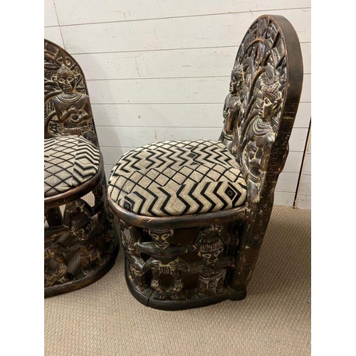 139 - A pair of carved seats with tribal theme carving to back and base