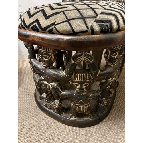 139 - A pair of carved seats with tribal theme carving to back and base