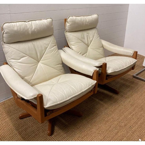 154 - A pair of Norwegian Lied Mobler teak and white leather revolving and reclining chairs