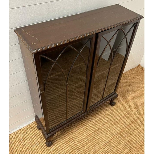 162 - An oak slim display cabinet on ball and claw feet (H114cm W90cm D28cm)