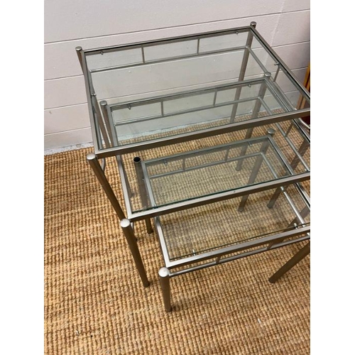 171 - A nest of three chrome and glass square tables