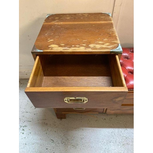 179 - A military campaign style telephone bench with red leather buttoned seat AF (H72cm W90cm D37cm)