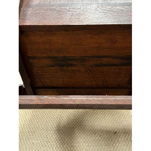 258 - A solid oak Tudor Revival Glastonbury chair, with shaped arms and x frame legs with joints held with... 