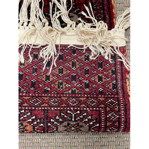 295 - A Yallameh style rug with red ground (114cm x 64cm)