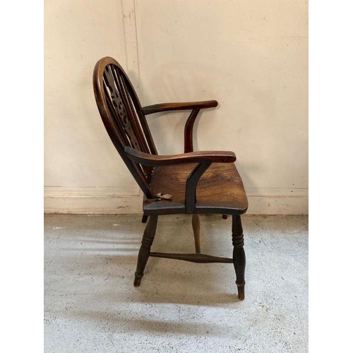 40 - A dark oak wheel back arm chair