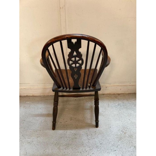 40 - A dark oak wheel back arm chair
