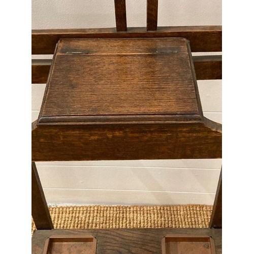 65 - An oak hall stand with six hooks, central mirror and hinged storage to centre AF (H182cm W64cm D25cm... 