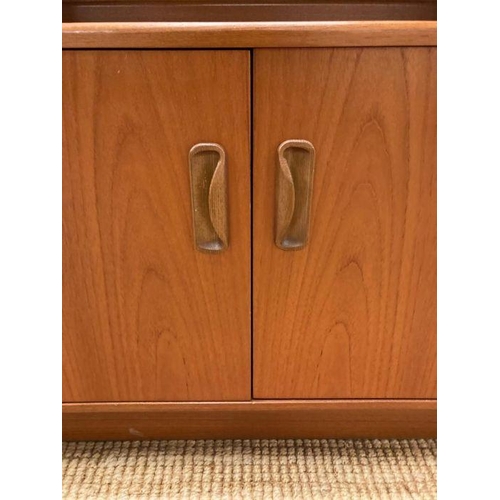 66 - A G-Plan wall unit with two glazed doors and three shelves to top and a two door cupboard to bottom ... 