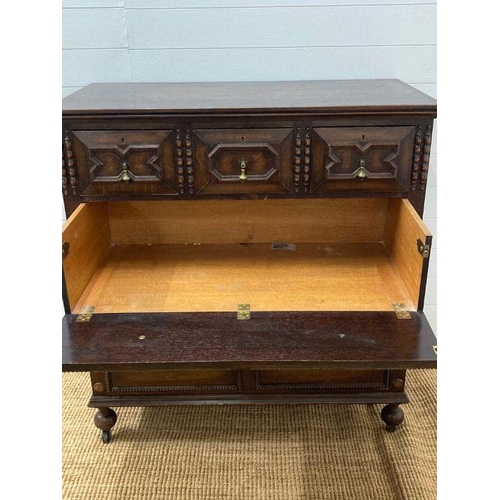 68 - An oak Jacobean style three over three chest of drawers with central drop down front (H110cm W107cm ... 