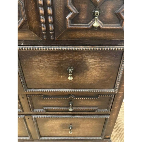 68 - An oak Jacobean style three over three chest of drawers with central drop down front (H110cm W107cm ... 