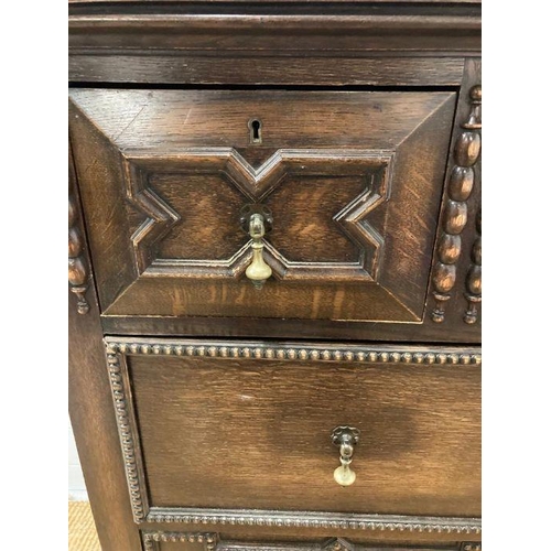 68 - An oak Jacobean style three over three chest of drawers with central drop down front (H110cm W107cm ... 