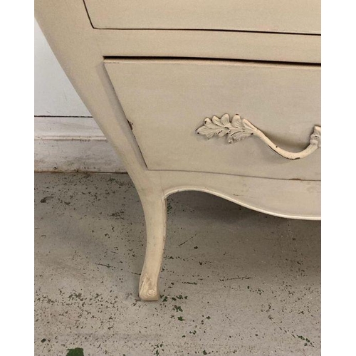 87 - A white painted Louis XV style Bombe commode with three drawers and down swept legs