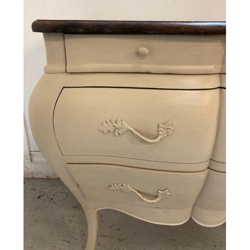 87 - A white painted Louis XV style Bombe commode with three drawers and down swept legs