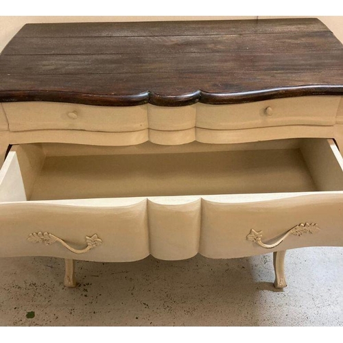 87 - A white painted Louis XV style Bombe commode with three drawers and down swept legs