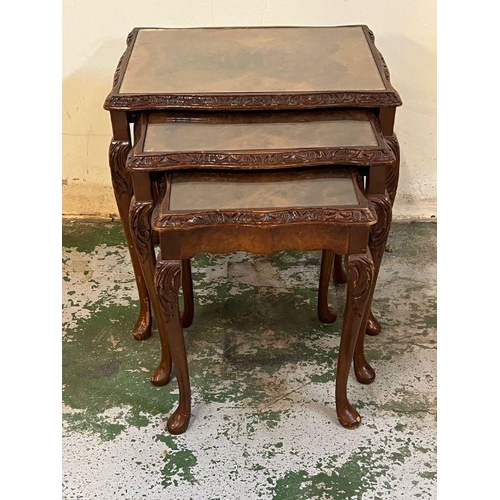 110 - A nest of three mahogany glass top tables