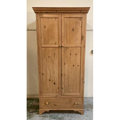 127 - A two door pine wardrobe with drawer under (H200cm W95cm D66cm)