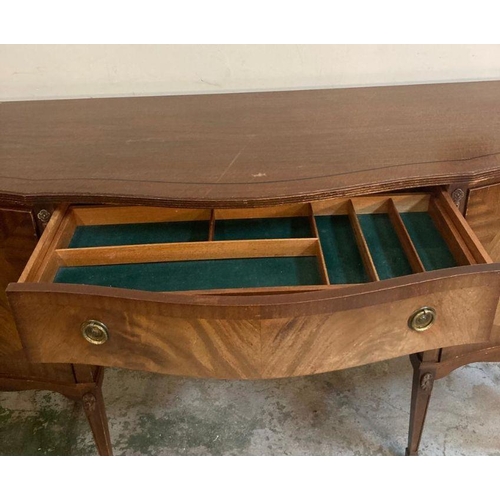 139 - A mahogany serpentine fronted sideboard, two drawers flanked by cupboards and ornate floral carving