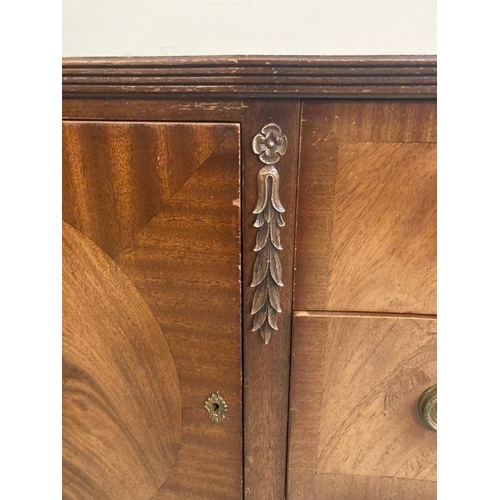 139 - A mahogany serpentine fronted sideboard, two drawers flanked by cupboards and ornate floral carving