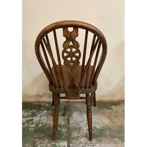 147 - Four oak vintage wheel back dining chairs