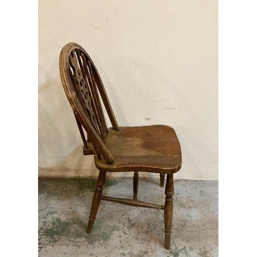 148 - Four oak vintage wheel back dining chairs