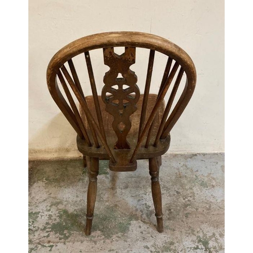 148 - Four oak vintage wheel back dining chairs