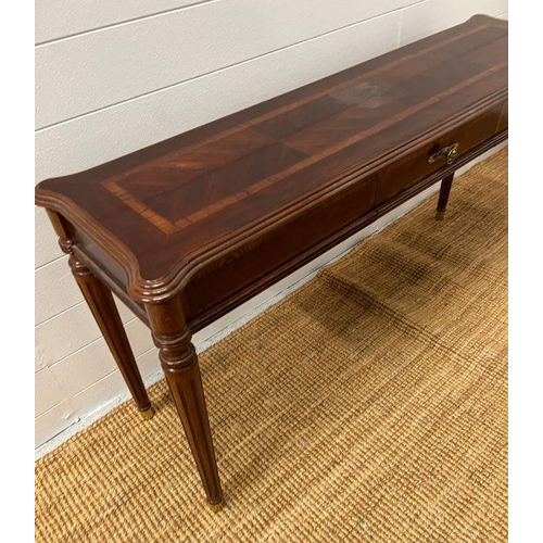 173 - A console table with drawer to centre on fluted legs (H69cm W135cm D40cm)