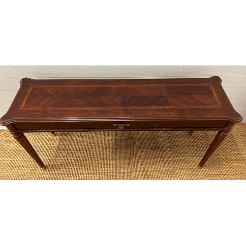 173 - A console table with drawer to centre on fluted legs (H69cm W135cm D40cm)