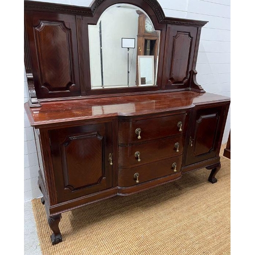 177 - A mahogany sideboard, the arched mirror back flanked by panelled sides, on a breakfront base with de... 