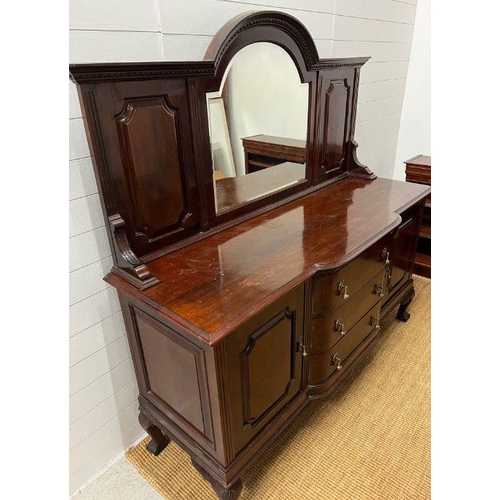 177 - A mahogany sideboard, the arched mirror back flanked by panelled sides, on a breakfront base with de... 