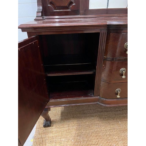 177 - A mahogany sideboard, the arched mirror back flanked by panelled sides, on a breakfront base with de... 