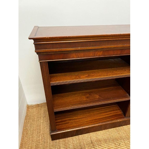 179 - A mahogany double open bookcase stand upon a plinth base (H92cm W52cm D35cm)