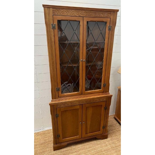 212 - A glazed corner unit (H174cm W77cm D58cm)