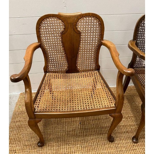 217 - A pair of cane arm chairs with walnut frame (One AF)