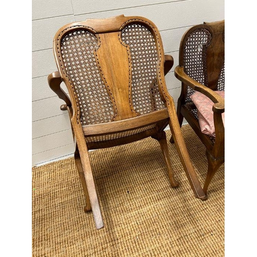 217 - A pair of cane arm chairs with walnut frame (One AF)