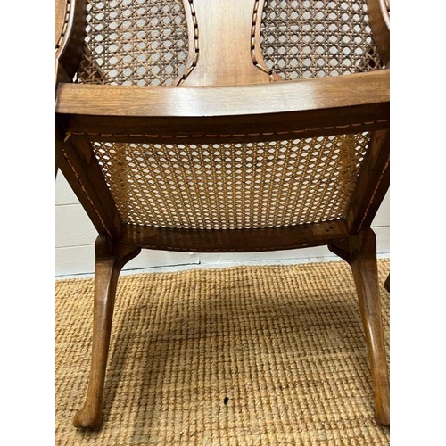 217 - A pair of cane arm chairs with walnut frame (One AF)