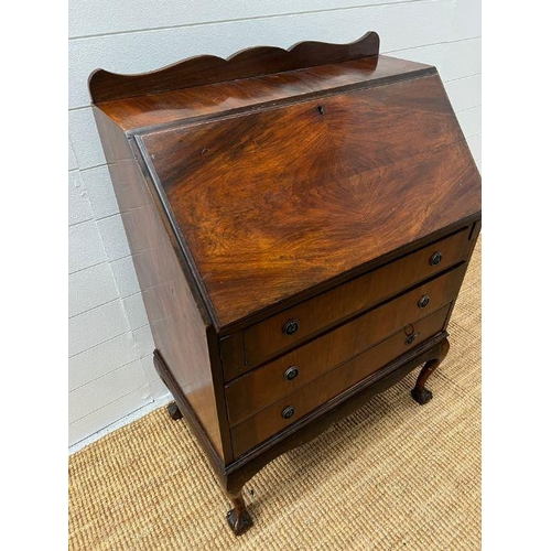 221 - A mahogany bureau, the fall enclosing interior fitted above three long drawers (H100cm W75cm D43cm)