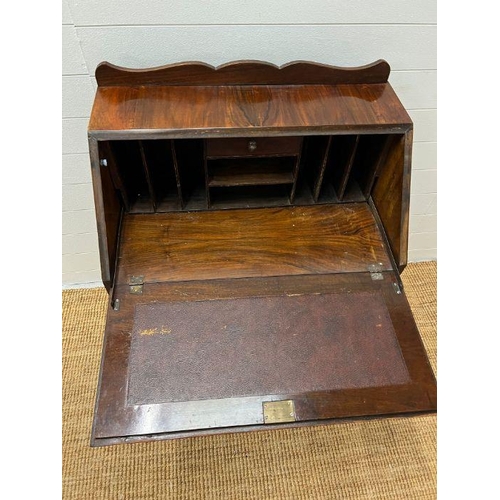 221 - A mahogany bureau, the fall enclosing interior fitted above three long drawers (H100cm W75cm D43cm)