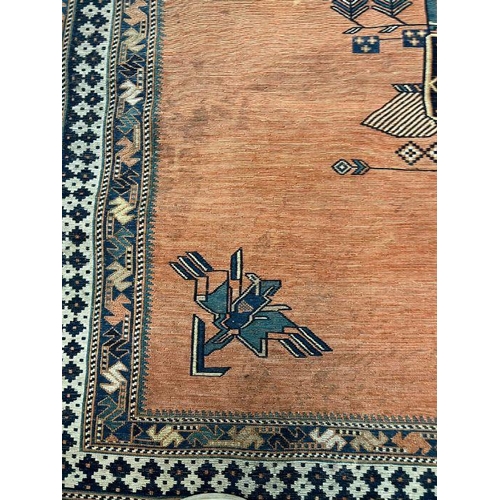 230 - A Geometric orange grounds rug (SQ143cm)