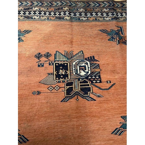 230 - A Geometric orange grounds rug (SQ143cm)