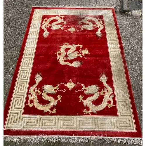 232 - A red ground dragon motif silk rug