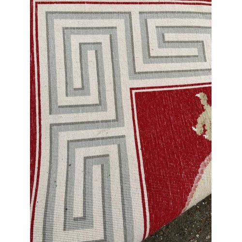 232 - A red ground dragon motif silk rug