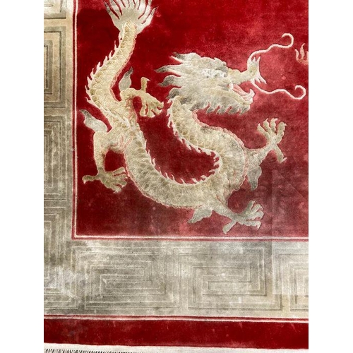 232 - A red ground dragon motif silk rug