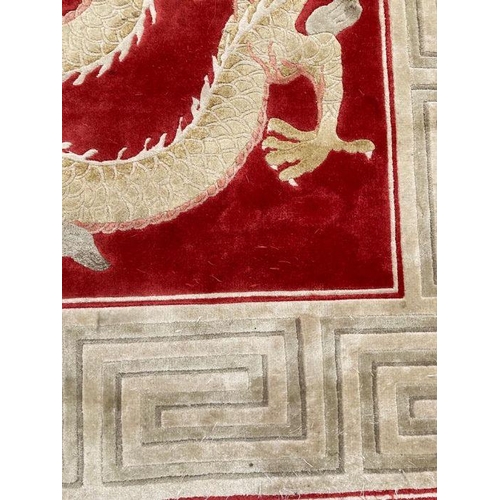 232 - A red ground dragon motif silk rug