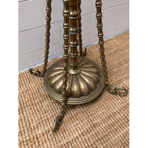 249 - A Victorian brass floor standing oil lamp on four legs with foliate details