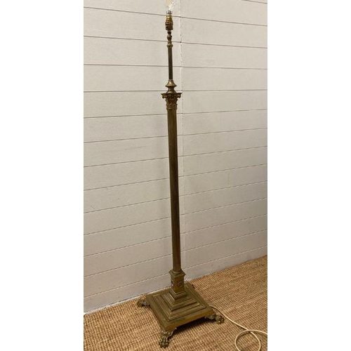 250 - A brass Corinthian column floor standing lamp on a square base with lion paw feet