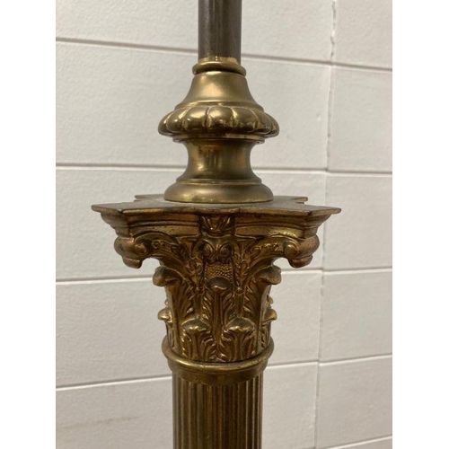 250 - A brass Corinthian column floor standing lamp on a square base with lion paw feet