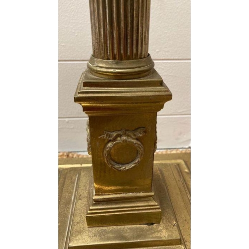 250 - A brass Corinthian column floor standing lamp on a square base with lion paw feet