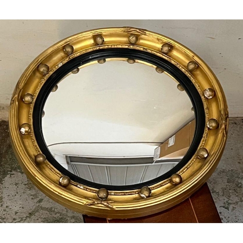 254 - A Regency convex gilt wood wall mirror